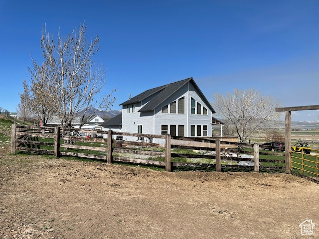 View of side of home featuring a rural view