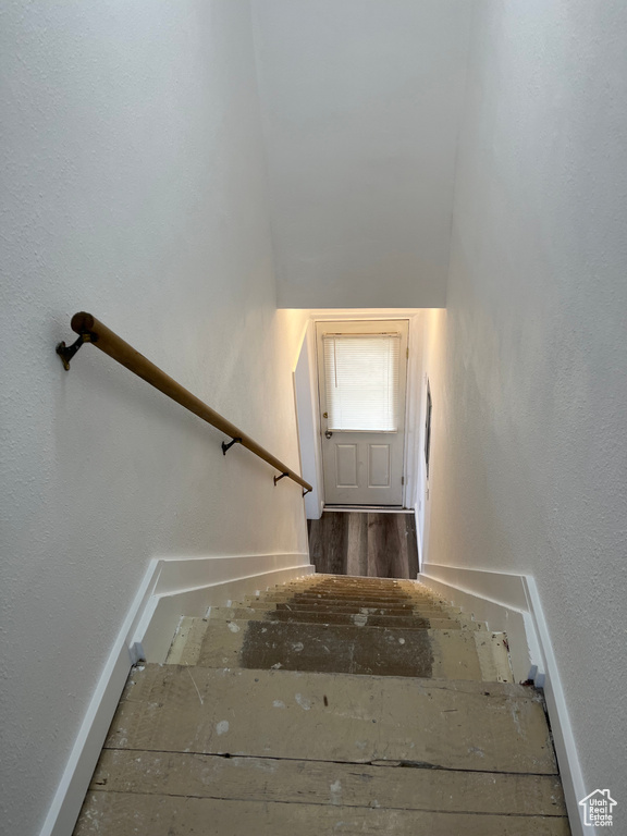 Stairway with dark hardwood / wood-style flooring