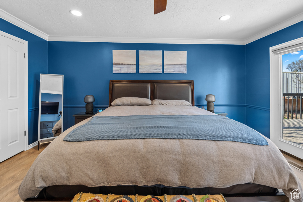Bedroom featuring crown molding, ceiling fan, access to outside, and light hardwood / wood-style floors