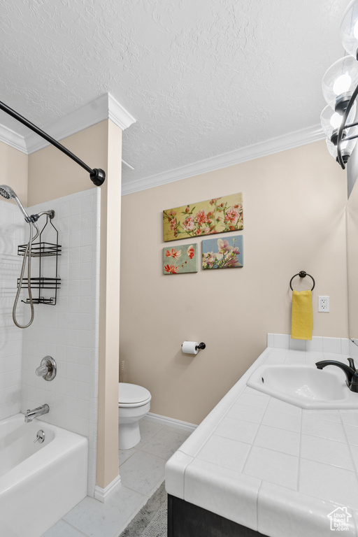 Full bathroom featuring crown molding, toilet, tiled shower / bath combo, a textured ceiling, and tile floors