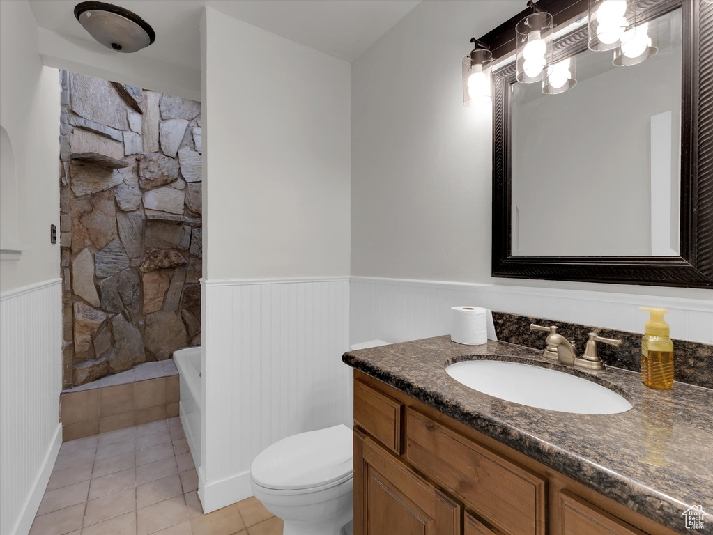 Bathroom featuring tile flooring, toilet, and vanity