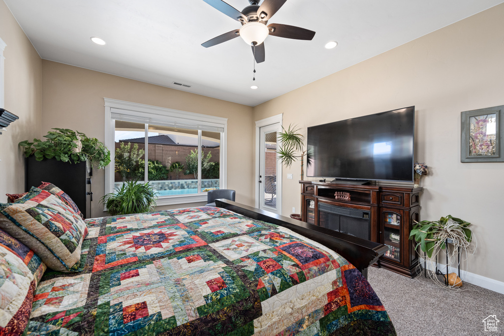 Bedroom with light carpet, ceiling fan, and access to exterior
