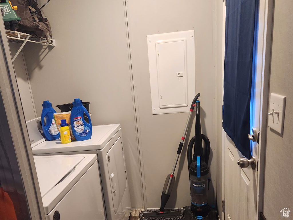 Laundry room with dark hardwood / wood-style floors and washer and clothes dryer