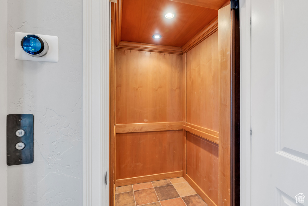 Details with elevator and light tile flooring