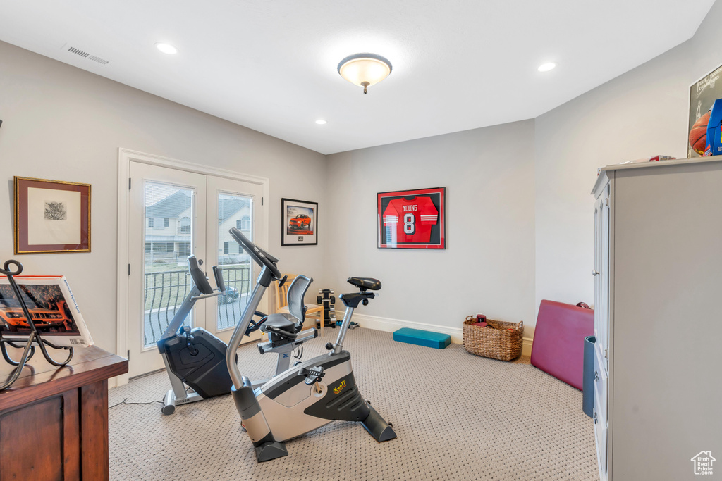 Workout room featuring light colored carpet and french doors