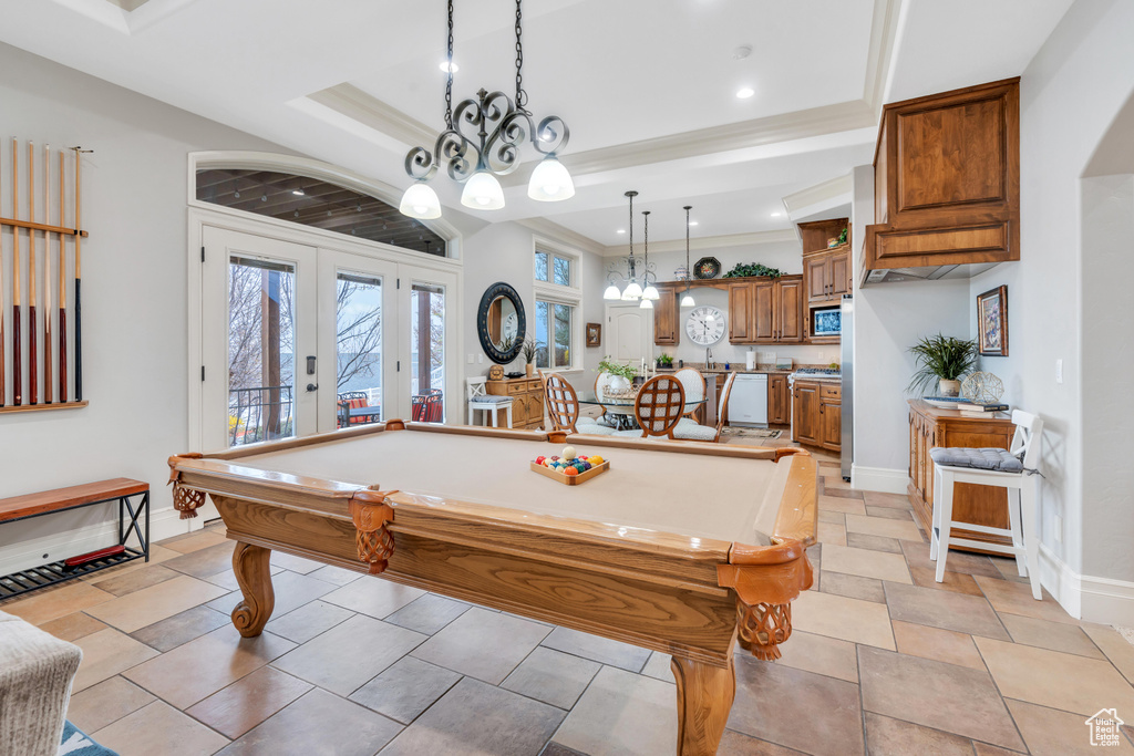 Recreation room featuring french doors, a raised ceiling, light tile floors, and pool table