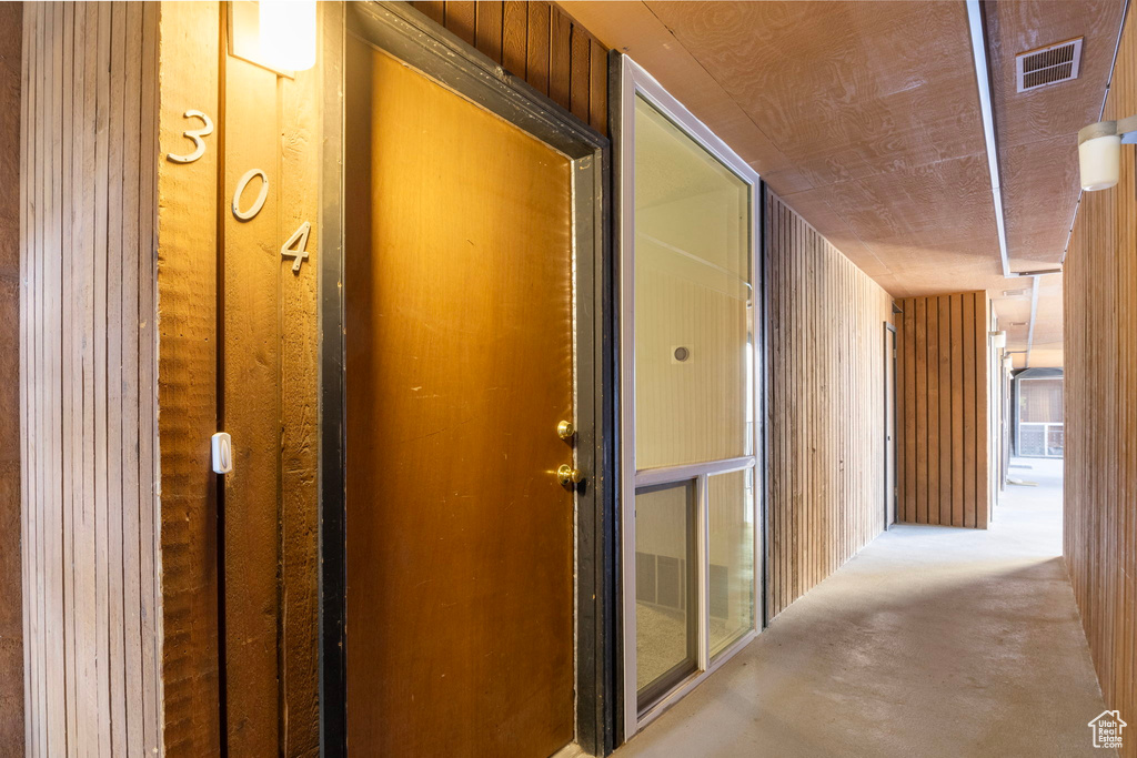 Hallway with wood walls