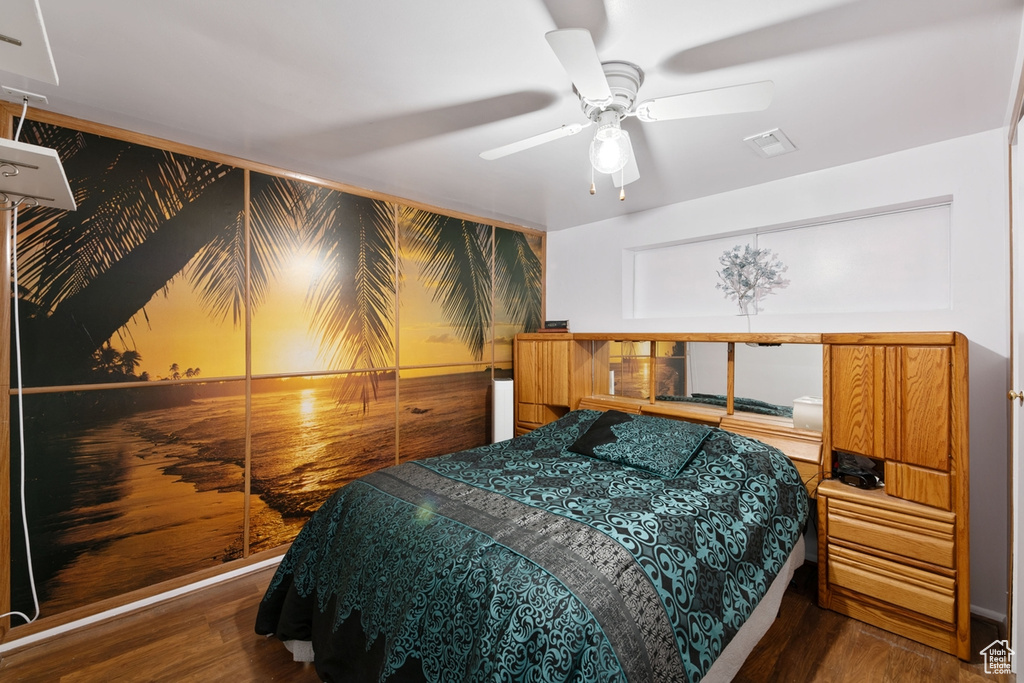 Bedroom with ceiling fan and dark hardwood / wood-style flooring