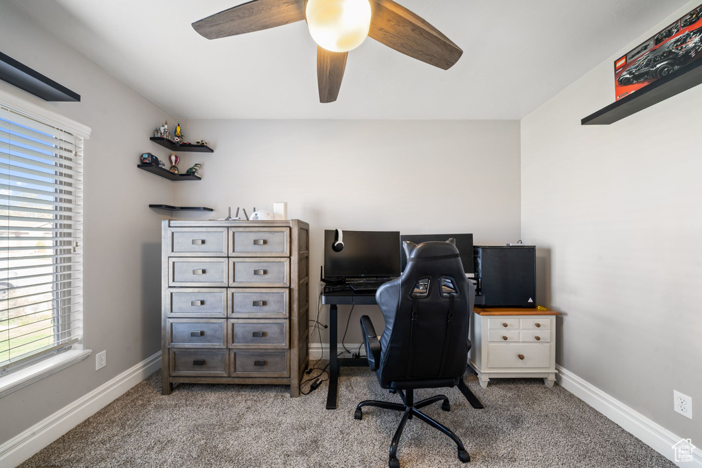 Carpeted office space with ceiling fan