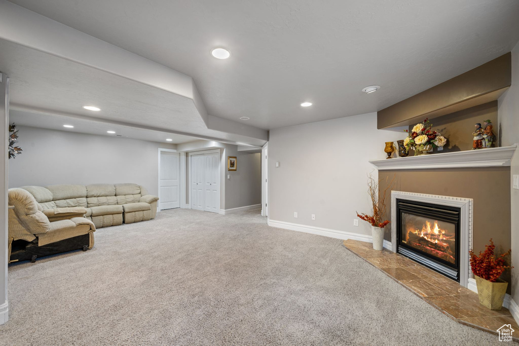 Carpeted living room featuring a fireplace