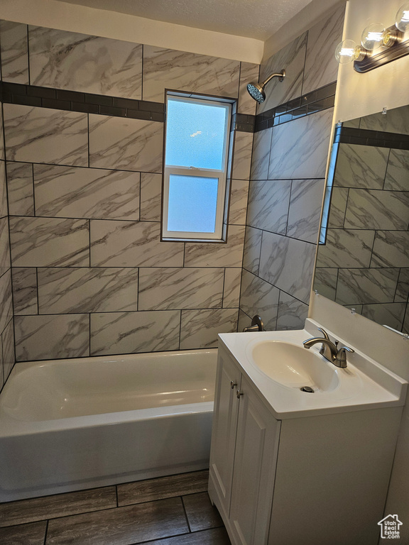 Bathroom with tiled shower / bath combo and large vanity