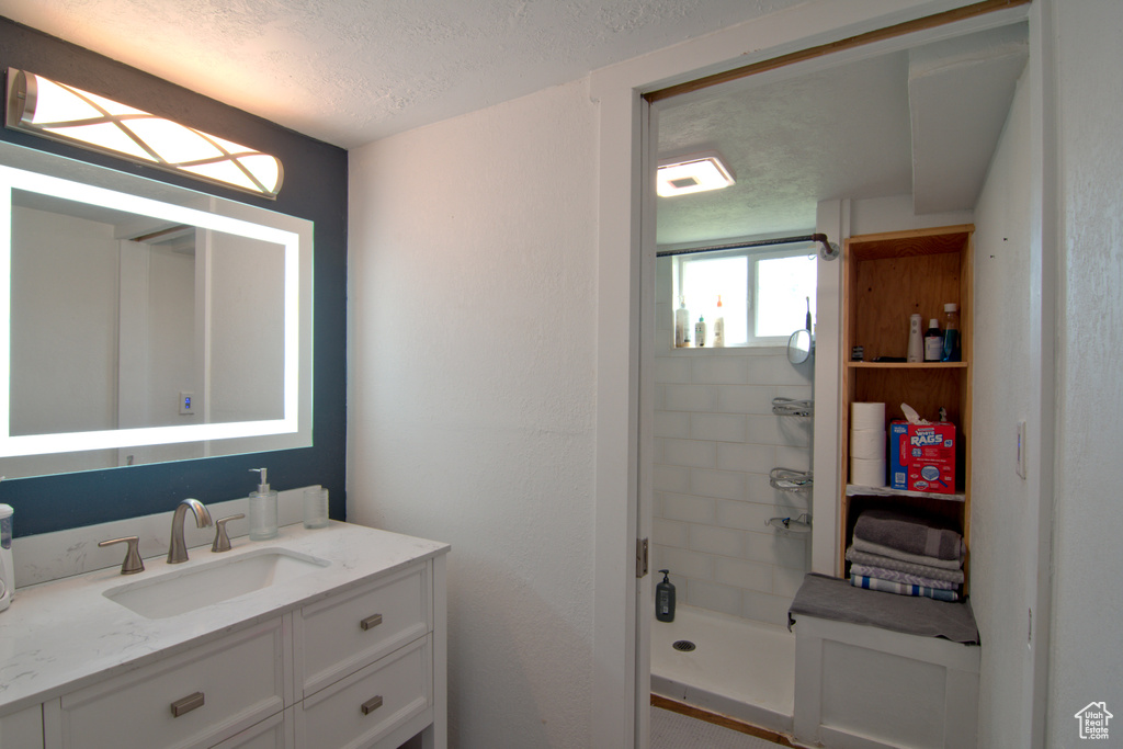 Bathroom with vanity and a textured ceiling