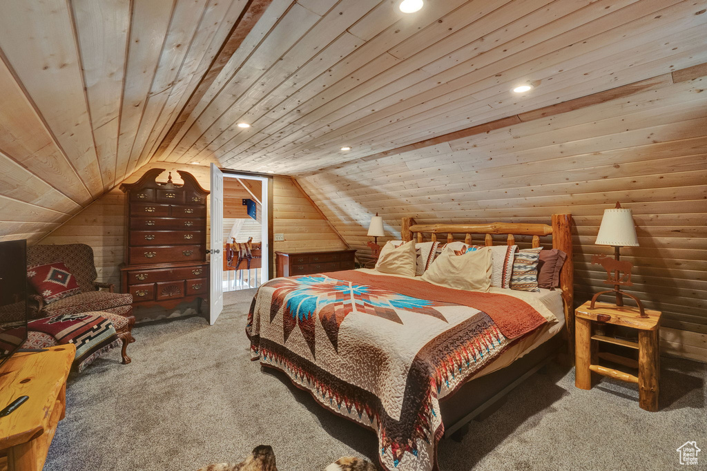 Bedroom featuring vaulted ceiling, light carpet, and wooden ceiling