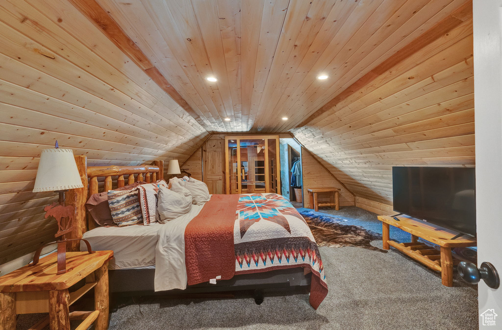 Carpeted bedroom with lofted ceiling and wood ceiling