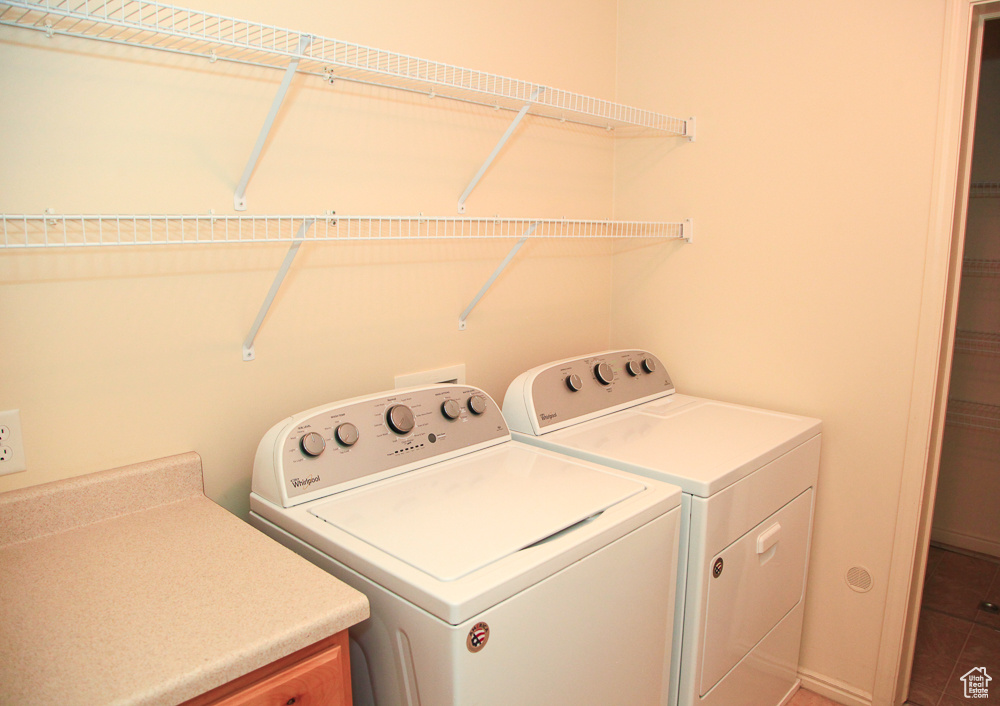 Washroom with independent washer and dryer and tile floors