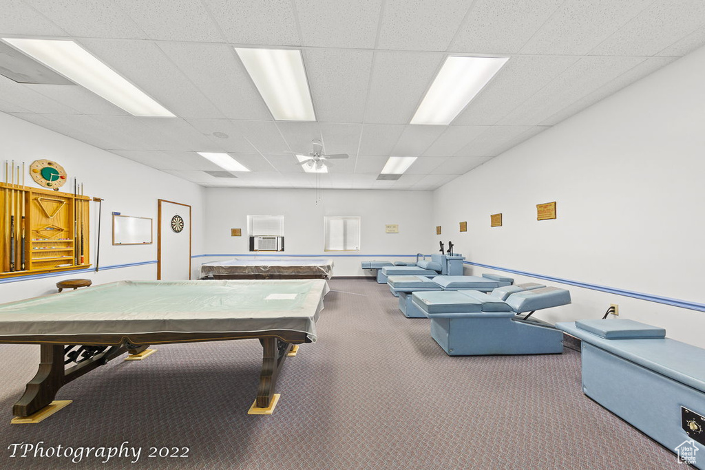 Recreation room with dark colored carpet, ceiling fan, a paneled ceiling, and billiards