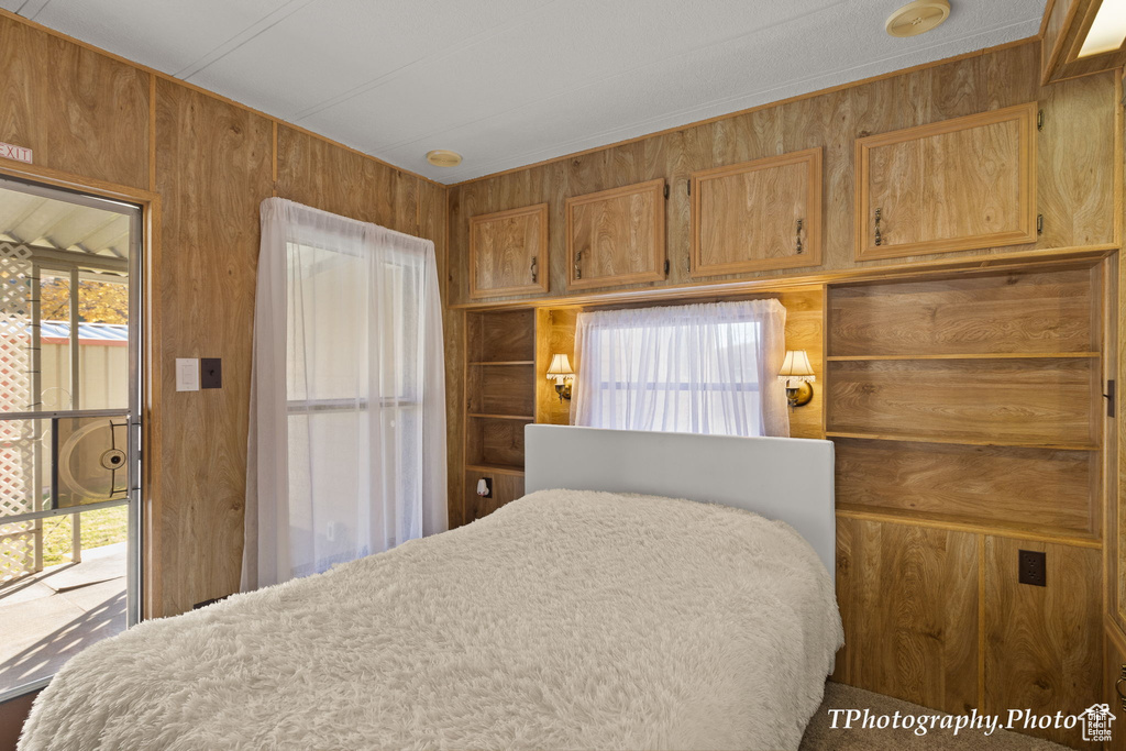 Bedroom with wood walls