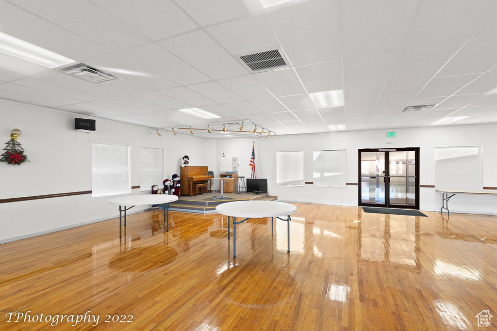 Recreation room featuring light hardwood / wood-style flooring and a paneled ceiling