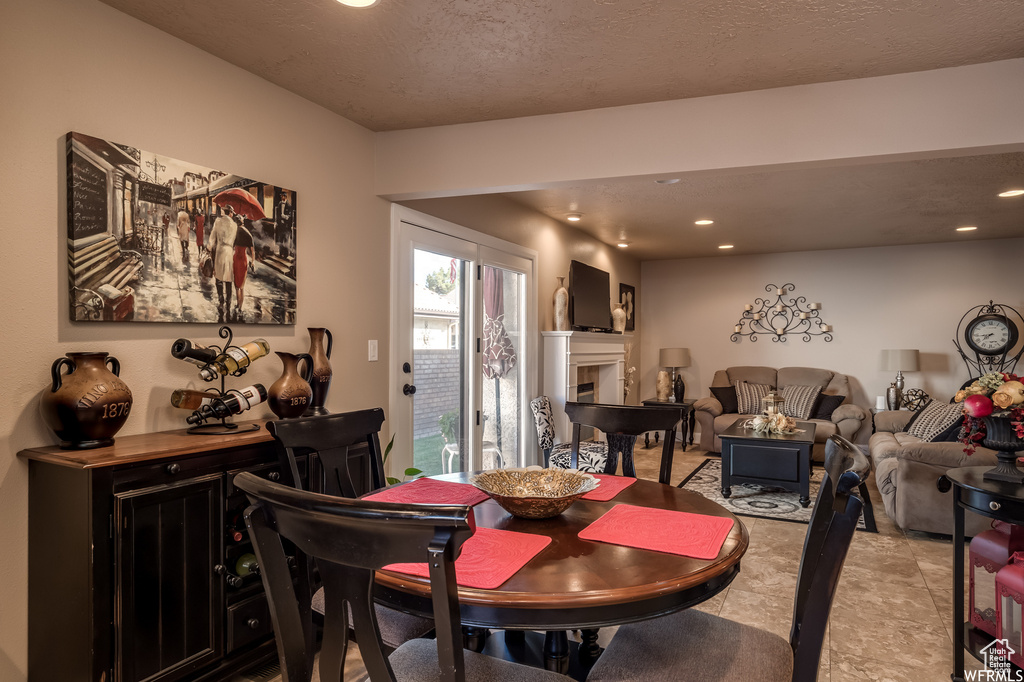 Tiled dining room with a textured ceiling