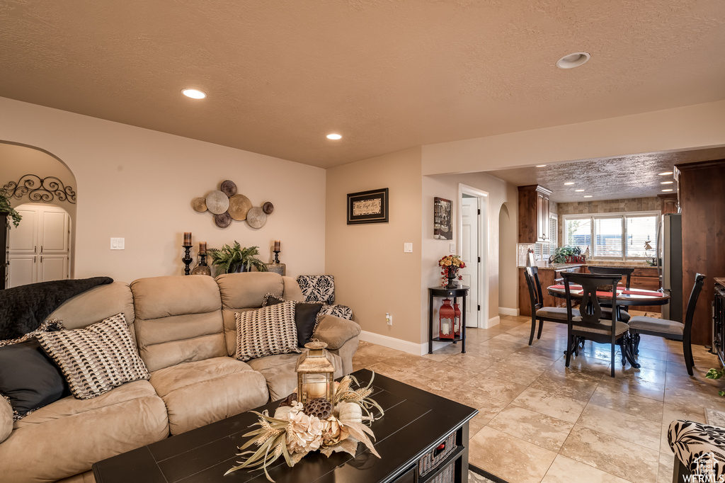 Tiled living room with a textured ceiling