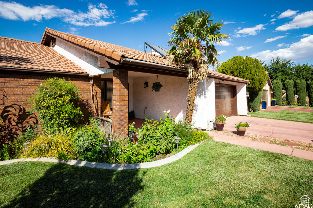 View of front of home with a garage and a front yard