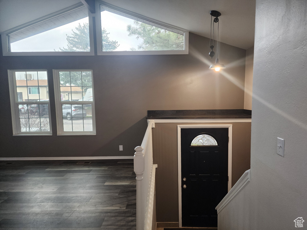 Entryway featuring dark hardwood / wood-style flooring and vaulted ceiling