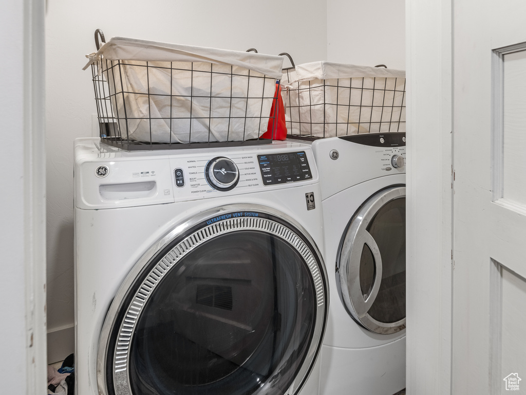Clothes washing area featuring washer and clothes dryer