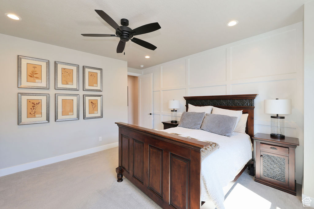 Bedroom featuring light carpet and ceiling fan