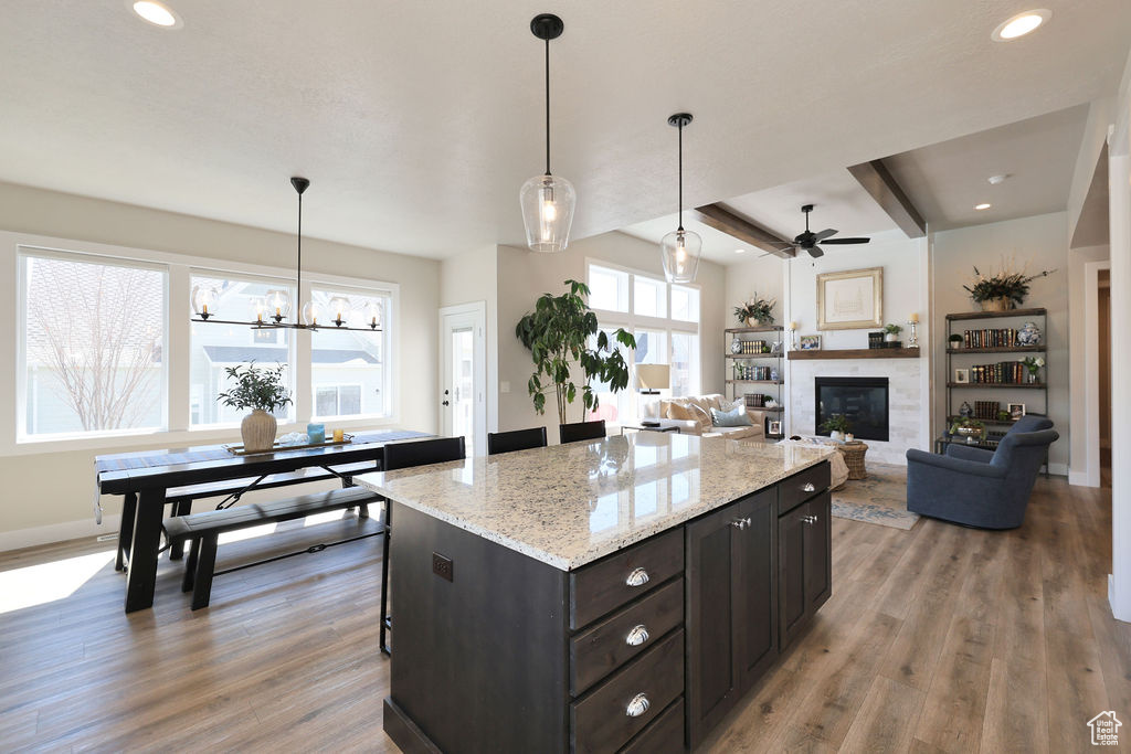 Kitchen featuring a kitchen island, pendant lighting, and light wood-type flooring