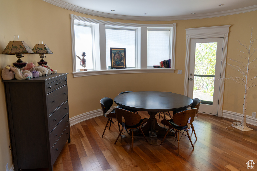 Dining area featuring crown molding and wood-type flooring