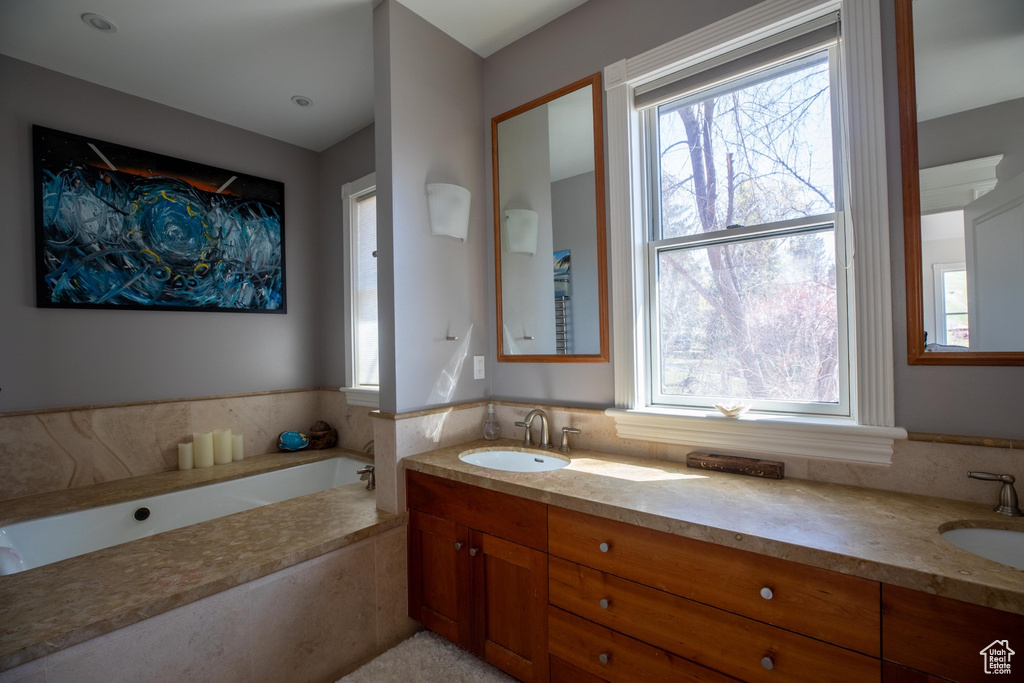 Bathroom with double sink vanity and a tub