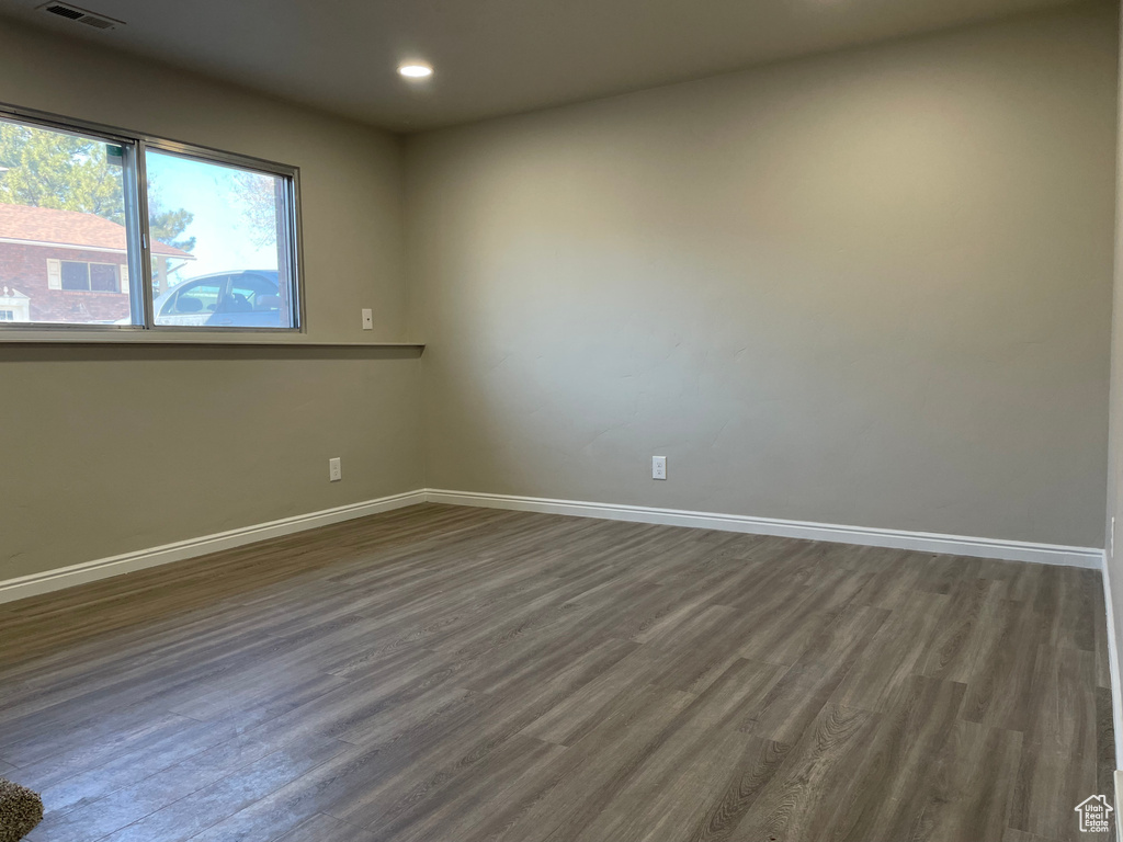 Spare room with dark hardwood / wood-style floors