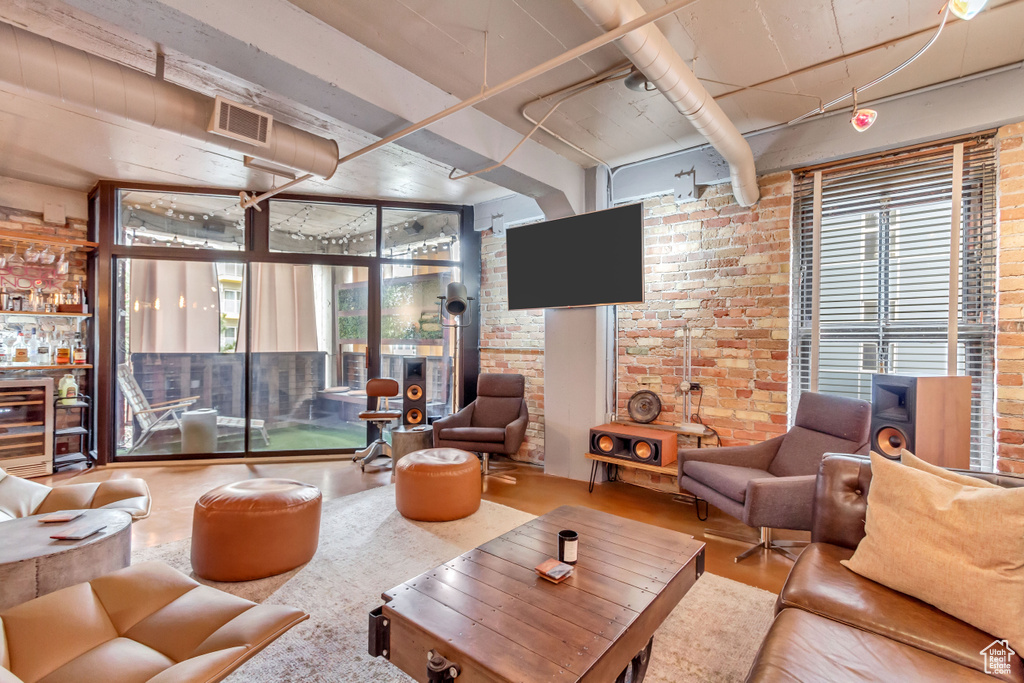 Living room featuring beverage cooler and brick wall
