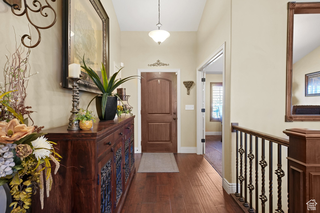 Entryway featuring dark wood-type flooring and vaulted ceiling