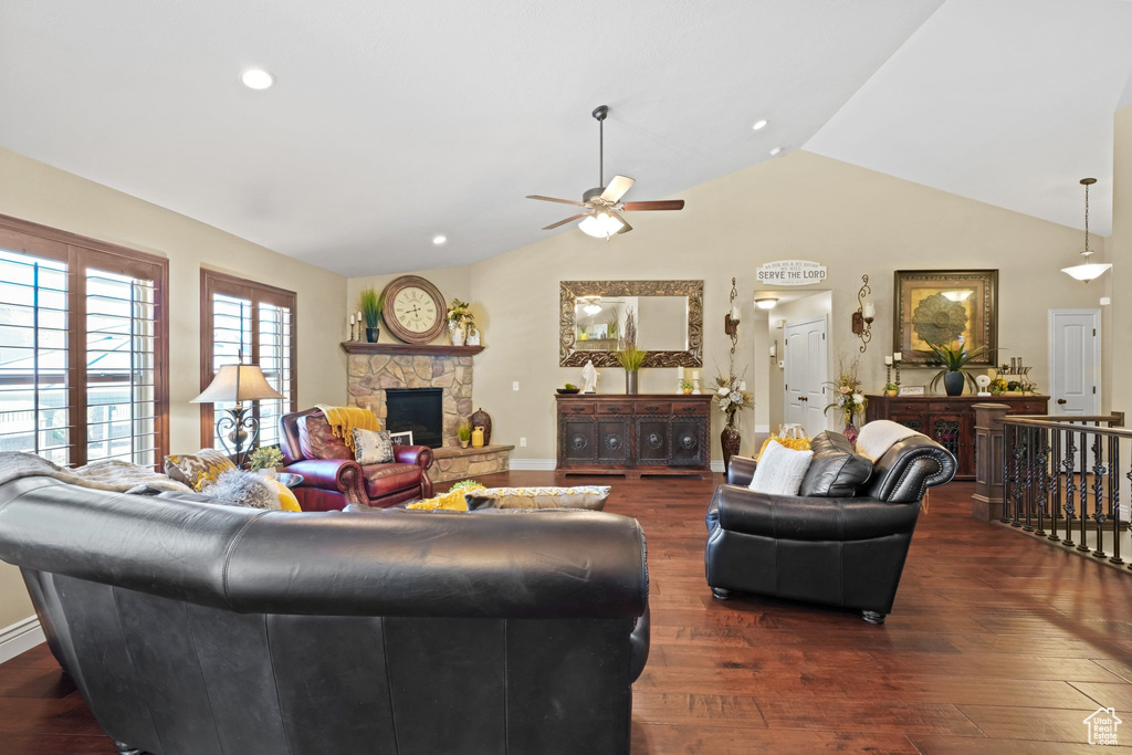 Living room featuring high vaulted ceiling, ceiling fan, a fireplace, and dark hardwood / wood-style floors