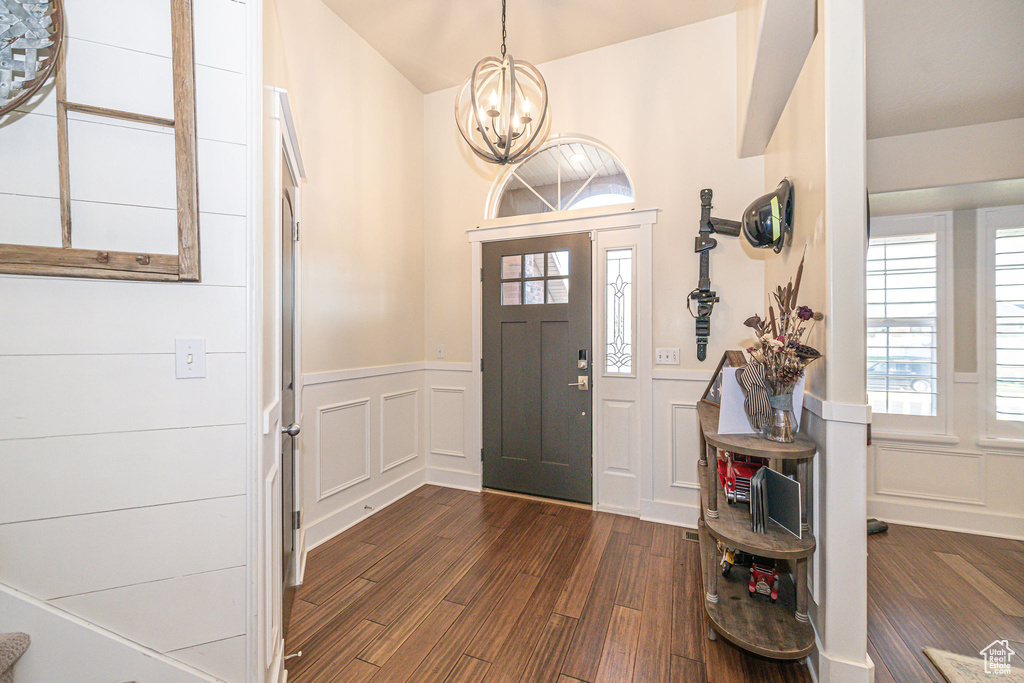 Entryway with a notable chandelier and dark hardwood / wood-style floors