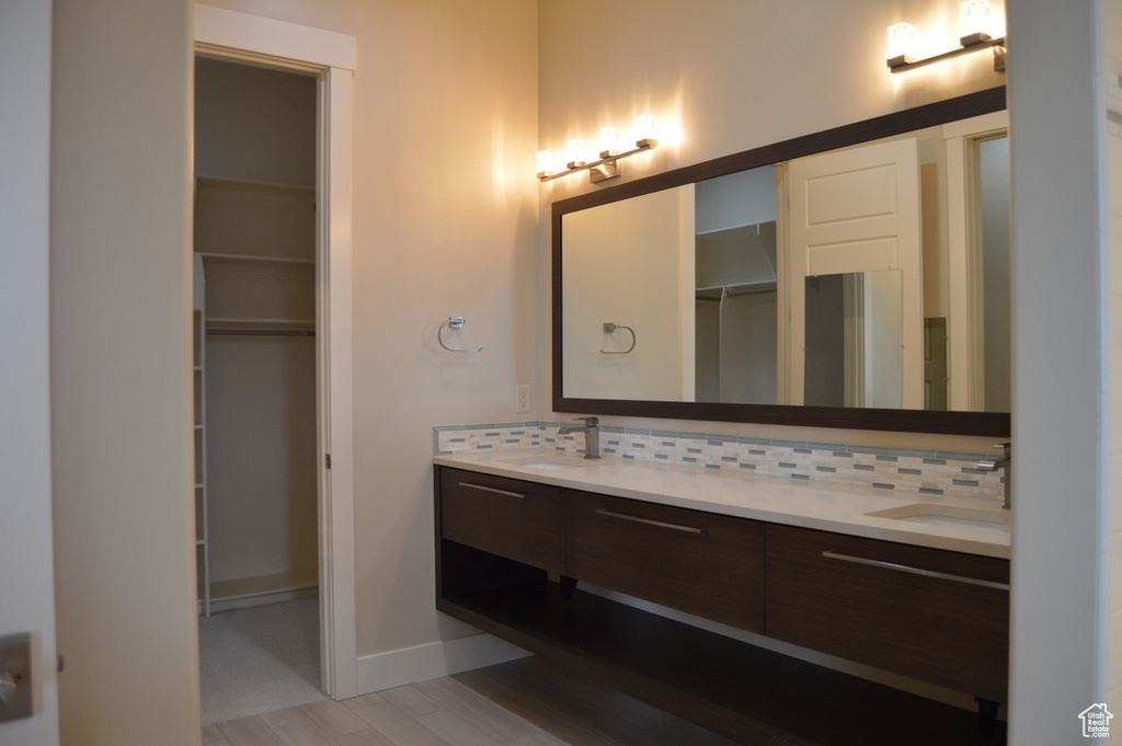 Bathroom featuring backsplash and double sink vanity