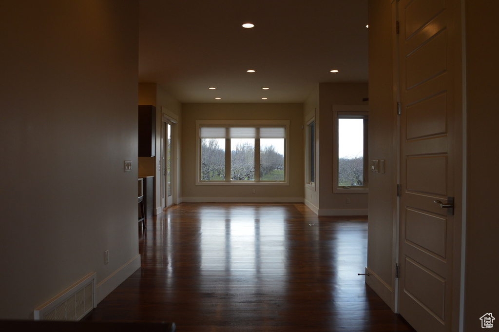 Corridor featuring dark wood-type flooring