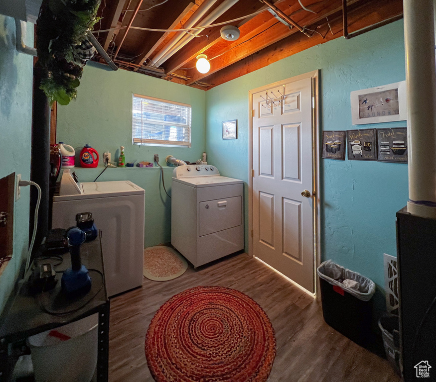 Washroom featuring washer and clothes dryer and dark hardwood / wood-style floors