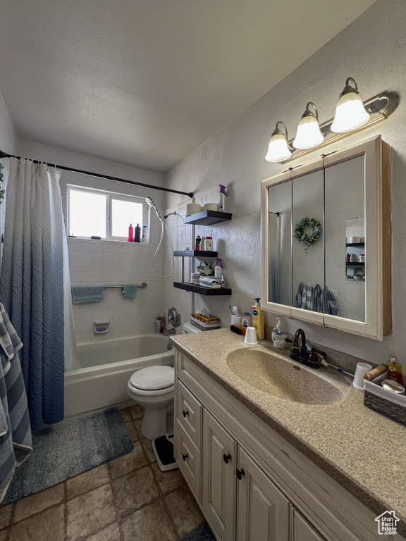 Full bathroom featuring tile floors, vanity, shower / bathtub combination with curtain, and toilet