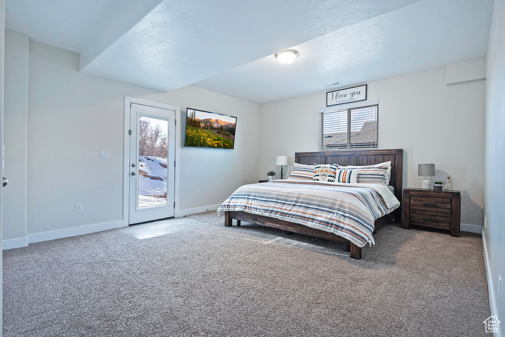 Bedroom featuring access to exterior and carpet floors