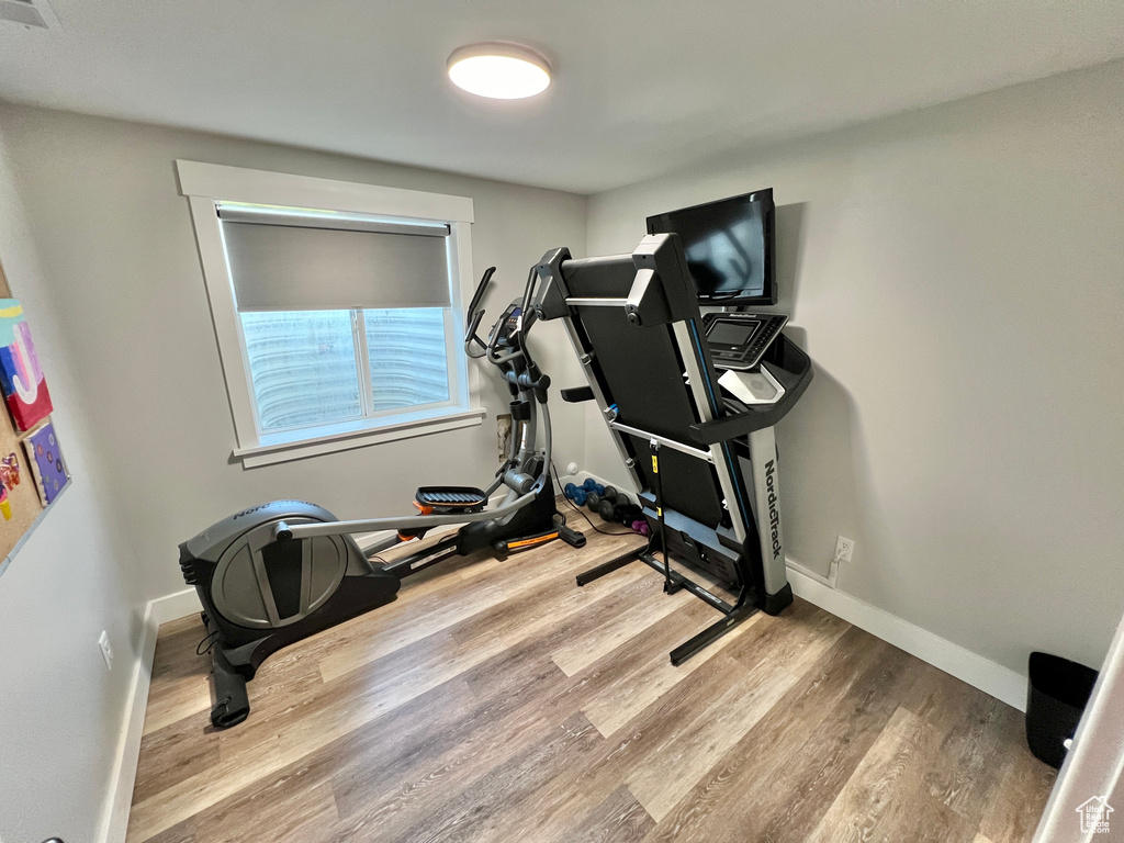 Workout room featuring light hardwood / wood-style flooring