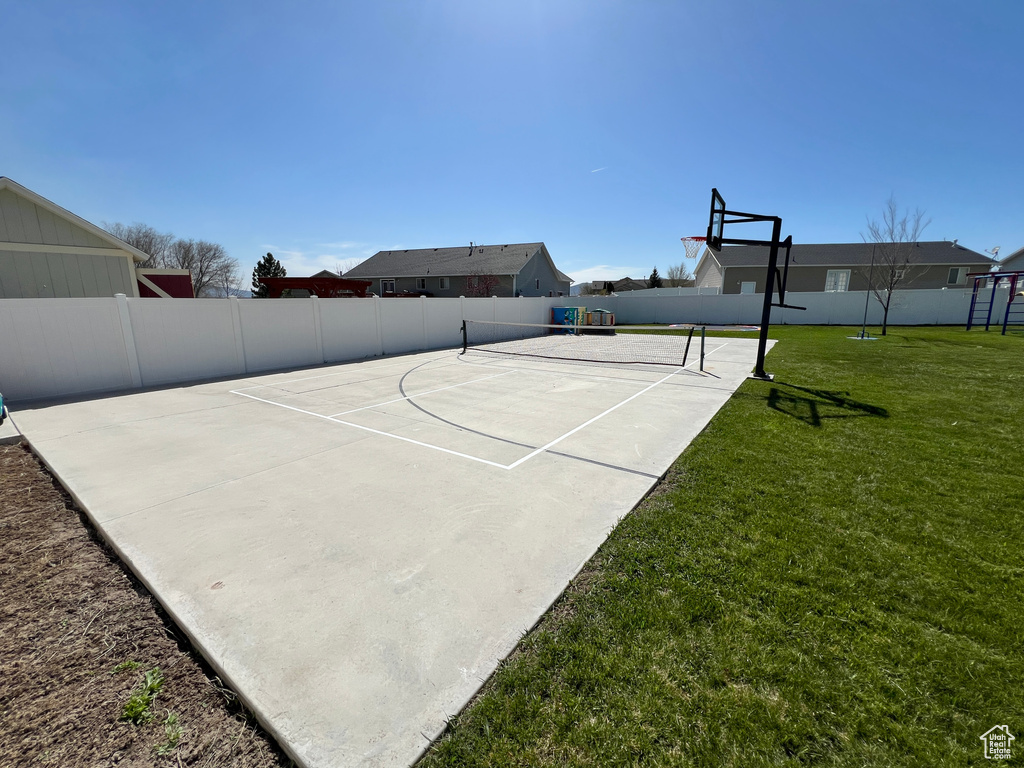 View of basketball court featuring a lawn