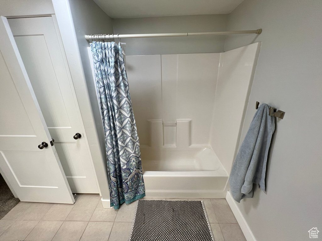 Bathroom with shower / bath combination with curtain and tile floors