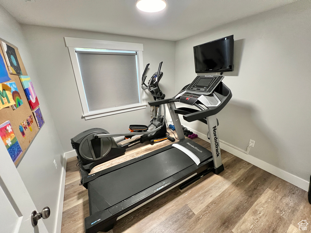 Workout room with light wood-type flooring