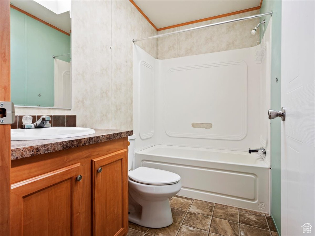 Full bathroom featuring tile flooring, toilet, bathtub / shower combination, and large vanity