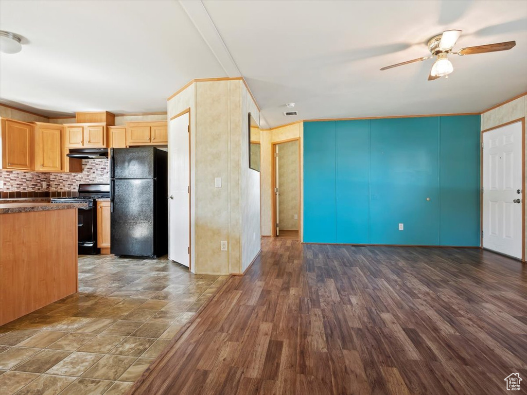 Kitchen with backsplash, ceiling fan, black appliances, light brown cabinetry, and tile floors