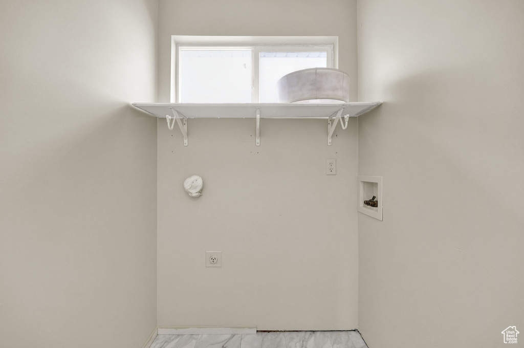 Washroom with light tile floors, washer hookup, and electric dryer hookup