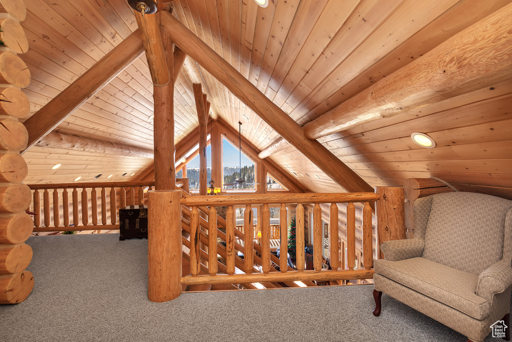 Living area featuring carpet, lofted ceiling with beams, and wooden ceiling
