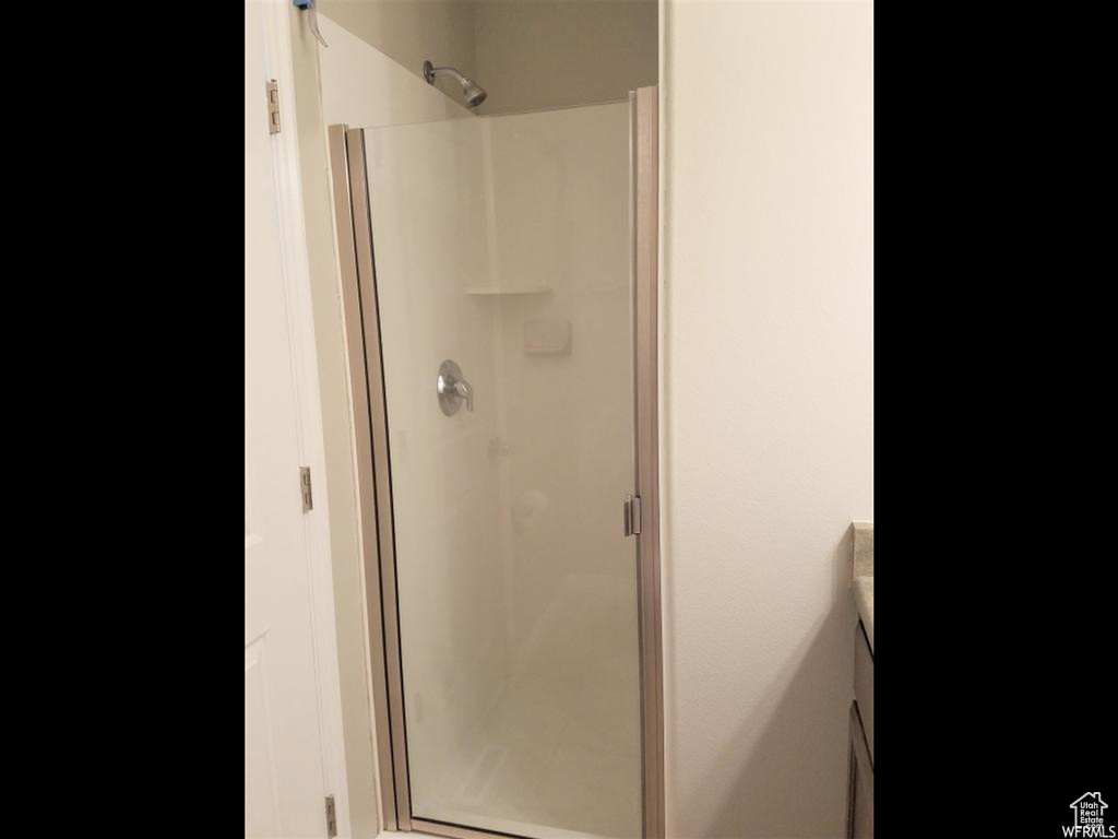 Bathroom with an enclosed shower and vanity
